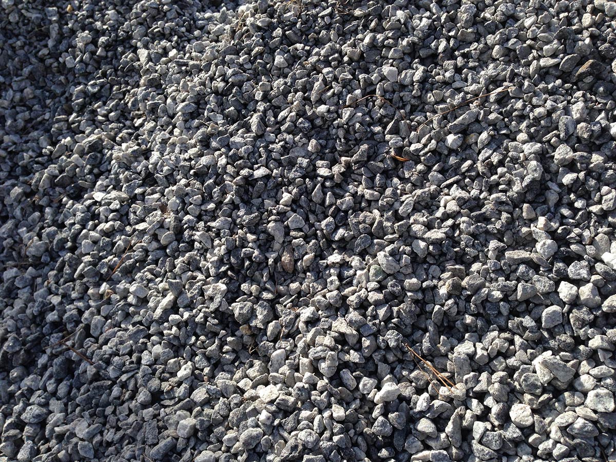 Crushed rock. Small rocks ground. Crushed stone road building